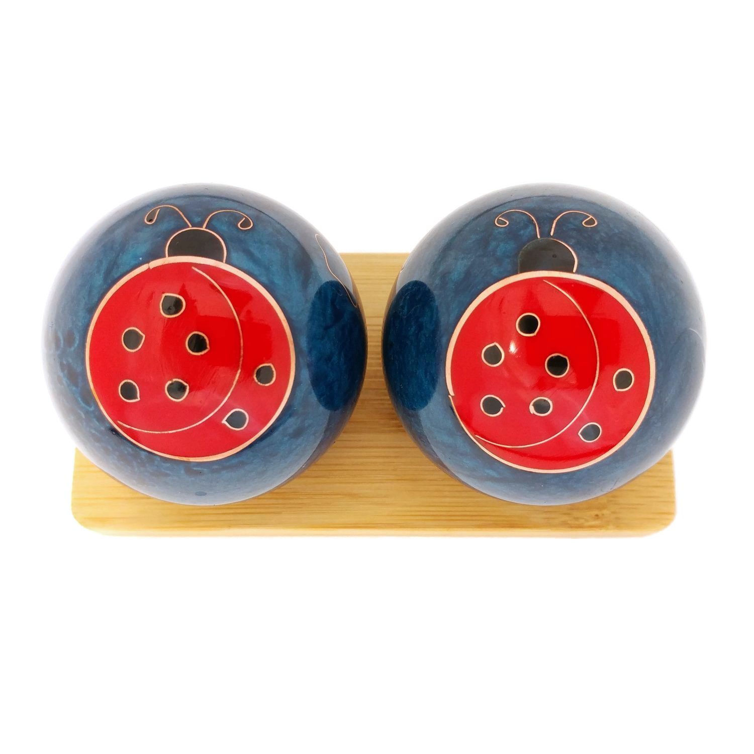Ladybug baoding balls on a display stand